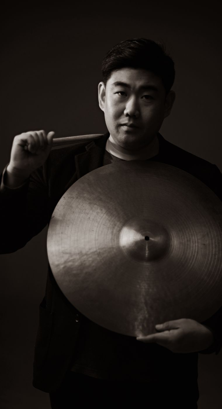 Minchan Kim holding a ride cymbal